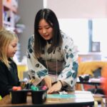 Photo of students from Japan visiting K-12 schools in La Crosse and taught students origami and Japanese calligraphy. (Photo credit: School District of La Crosse)