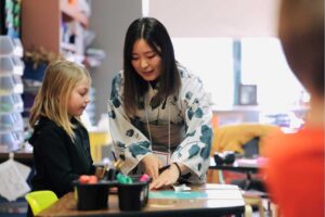 Photo of students from Japan visiting K-12 schools in La Crosse and taught students origami and Japanese calligraphy. (Photo credit: School District of La Crosse)