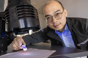 Photo of Qingsu Cheng, assistant professor of biomedical engineering at UWM, who is part of a team developing low-cost biosensors that can quickly identify foodborne bacteria using the fluorescence of quantum dots. (UWM Photo/Troye Fox)