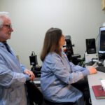 Photo of Jeffrey and Delinda Johnson working in their lab on the UW–Madison campus. Photo by Sally Griffith-Oh/UW–Madison