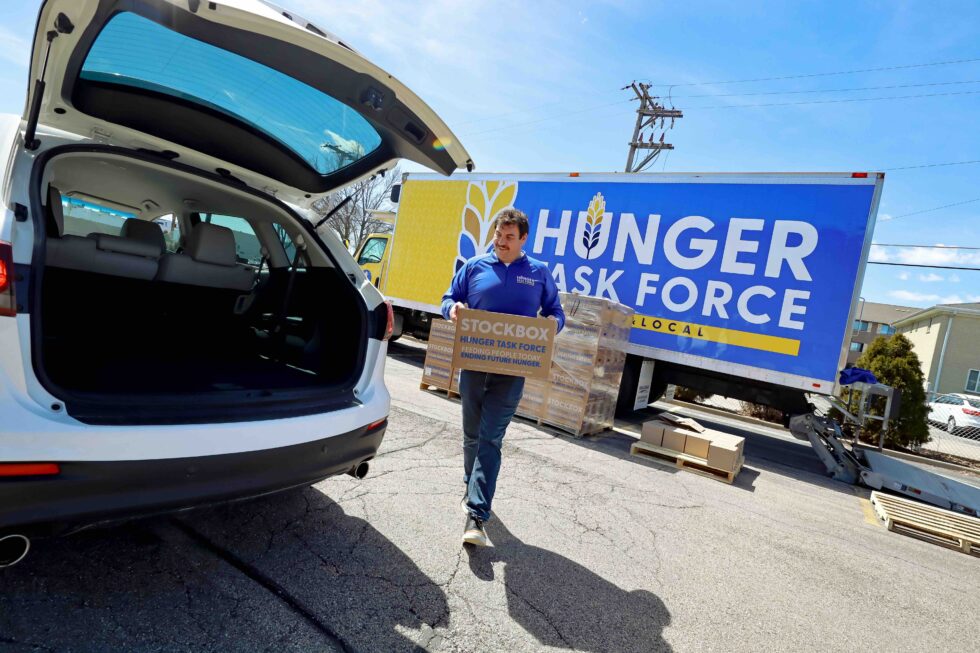 Photo of Rick Lewandowski, Milwaukee native and UW Oshkosh alum, who oversees 400 volunteers for the Hunger Task Force, delivering and distributing 10,000 boxes of healthy foods to low-income seniors free of charge.
