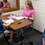 Photo of Blugold psychology graduate student Bryn Hermanson of Berlin working with an elementary school student under the supervision of Dr. Melissa Coolong-Chaffin, professor of psychology and co-director of the Academic Intervention Clinic.