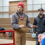 Photo of Kurt Vogel, UW-River Falls professor of animal welfare and behavior and director of the Humane Handling Institute, speaks with meat industry employees during a training session on effective and humane restraint and stunning of animals at the university’s Mann Valley Farm in November 2023. The Rosen Family Foundation, Inc. has given a $1 million gift to support the Humane Handling Institute. UWRF photo.