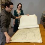 Photo of (from left) David Mindel and Nikki Pegarsch looking at charts from 1932 of locks and dams on Upper Mississippi River. Collections related to the Upper Mississippi River and Driftless Area have been growing organically on the UWL campus since the university's inception.