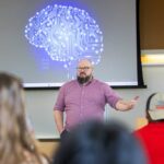 Photo of Stewart Eskew, assistant teaching professor of Philosophy, teaching a philosophy class at UW-La Crosse. The AI Ethics Certificate program will be housed within the Philosophy Department. Artificial intelligence (AI) ethics is a branch of ethics that explores complex ethical challenges posed by AI technologies.
