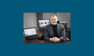 Photo of Scott Schanke, an assistant professor in UWM’s Lubar College of Business, who studies the design of artificial intelligence agents for public-facing business interactions, and how different interfaces can make or break consumer trust. (UWM Photo/Elora Hennessey)