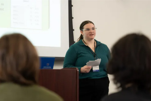 Photo of Casey presenting at CERCA: As part of the Provost's Honors Symposium during UW-Eau Claire's Celebration of Excellence in Research and Creative Activity (CERCA), Emily Casey and research teammates presented a study of student self-reported health and financial impacts of cannabis use. Dr. Aaron Willis, assistant professor of social work, served as faculty mentor.