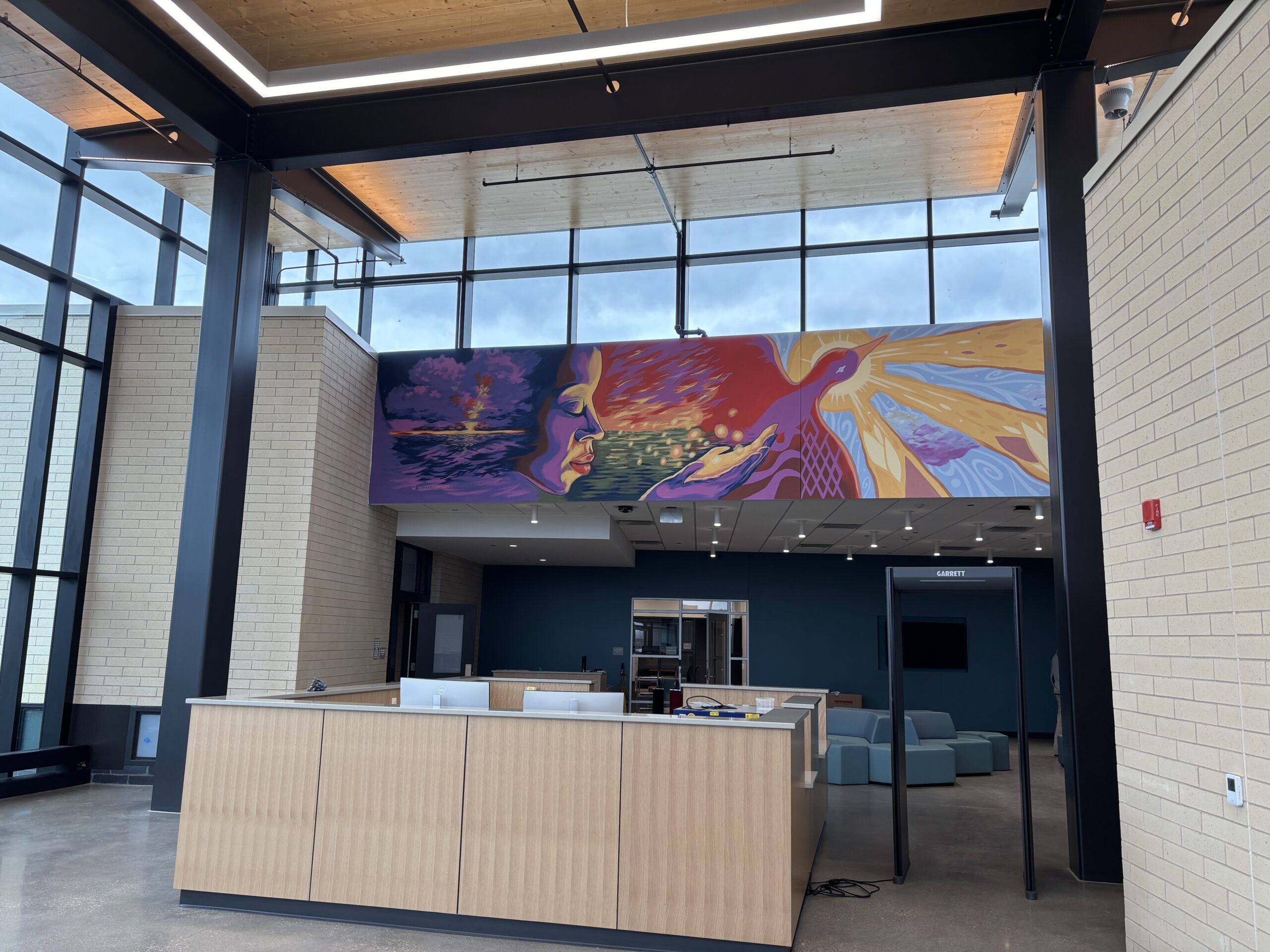 Photo of a brightly colored mural hanging in the lobby of the new Jonathan Delagrave Youth Development & Care Center based in the Village of Caledonia in Racine County. (UW-Parkside)