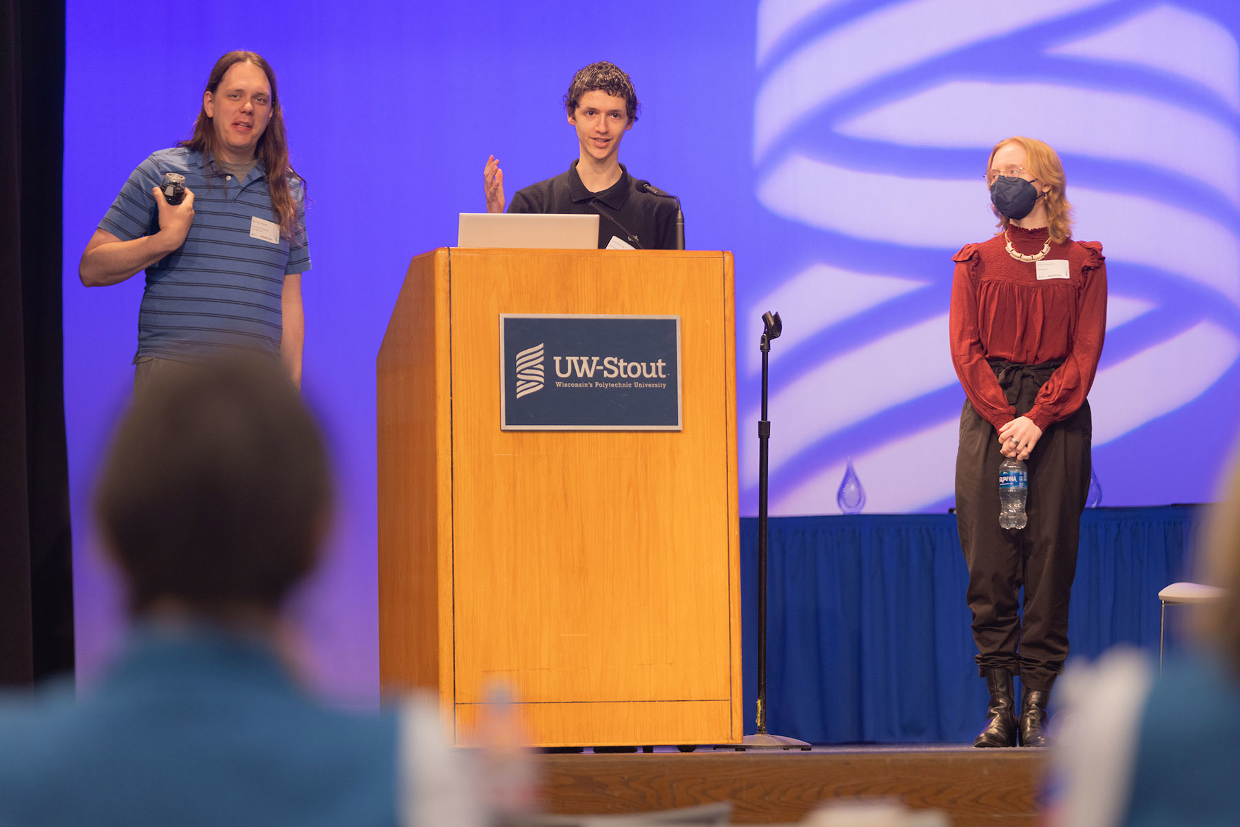 Photo: UW-Stout Assistant Professor Michael Tetzlaff, left, and students Luke Denney, at podium, and Chloe Ferguson gave a presentation about Kintsugi 3D at Research Day, May 6, 2025. / UW-Stout