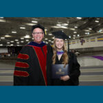 Photo of Perry and Stephanie Cook at the May 2025 commencement ceremony, where Perry was able to present his daughter with her diploma.