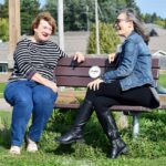Photo: Members of the Langlade County Healthy Aging in Rural Towns (HeART) coalition sit at one of the many HeART benches strategically placed around pedestrian areas to provide places to rest. (Photo by Heidi E. Johnson)