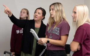 Photo: One of the fastest growing areas in Health Professions is Radiologic Sciences. From left, UWL student Ally Richarson, Director of Radiologic Sciences Melissa Weege, and UWL students Maddy Benson and Emma Strassburg are using VERT- radiation therapy virtual reality software.