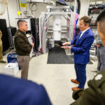Photo: In 2024, campus welcomed a delegation from the United States Cyber Command, which is responsible for the Department of Defense’s cyberspace capabilities. UW–Madison Physics professor Mark Eriksson (right) speaks with Lt. Gen. William J. Hartman, deputy commander of U.S. Cyber Command, during the delegation’s visit to multiple research labs across campus. Photo: Althea Dotzour / UW–Madison