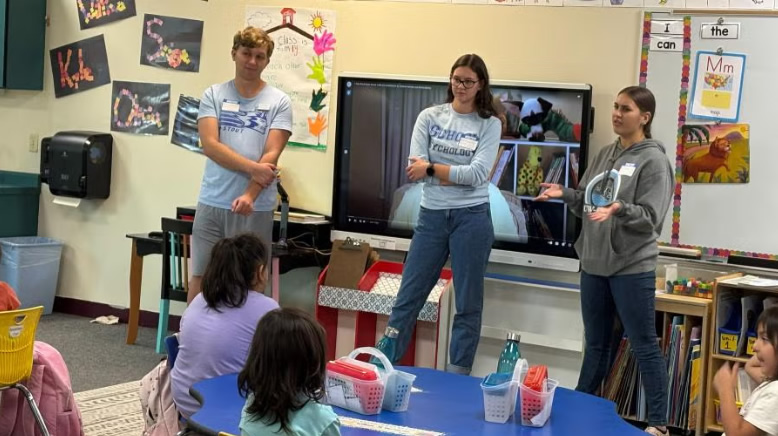 Photo of UW-Stout graduate students visiting Lac Courte Oreilles Ojibwe School; learning how language, culture directly impact students