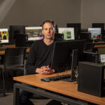 Photo of Adam Hudson leads Nonprof-IT, a program at UWM that connects student teams with local nonprofits in need of low-cost tech solutions. (UWM Photo/Andy Manis)