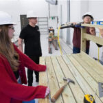 Photo: Madelyn Pretzer, Tanner Schauf, Brandy Wolf and Erika Rivolta build a tool bench for The Neighbors.