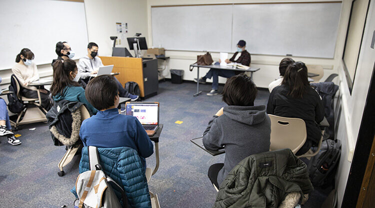 Photo by Afghan students Tahera and Farzana (center, in blue top and gray sweatshirt) listening during a writing class taught by Mark Sondrol, senior lecturer in the English Language Academy at UWM. (UWM Photo/Troye Fox)