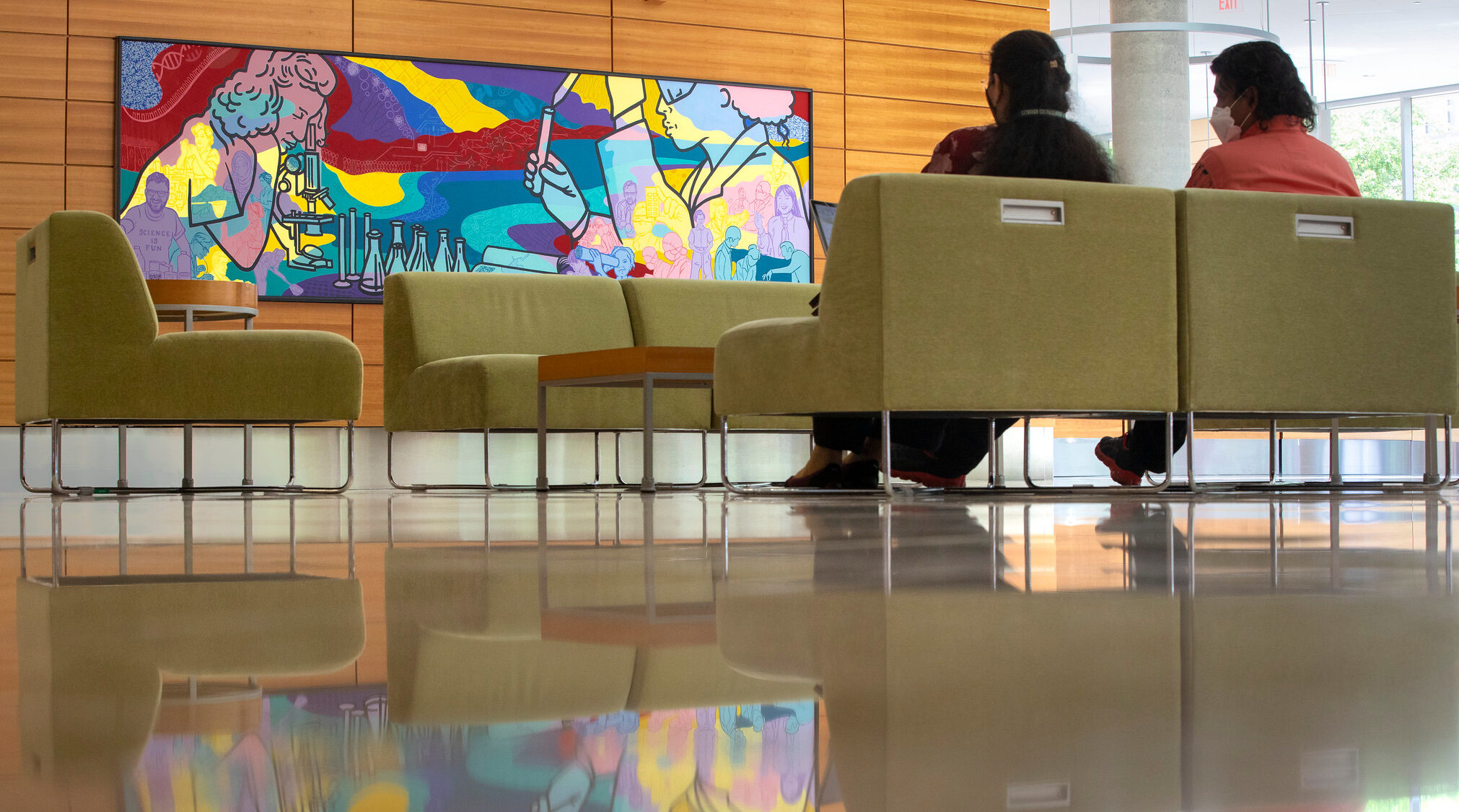 Photo of a mural by artists Alicia Rheal, Sharon Tang and Amy Zaremba now hanging in the Town Center of the Discovery Building. The Wisconsin Alumni Research Foundation commissioned the work, titled “Landscape of Discovery.” MICHAEL P. KING