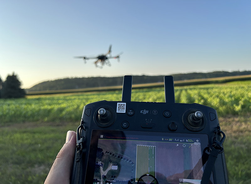 Photo: Lee Boles, a research manager at WinField United, uses a drone to spray a field of sunflowers which will later be assessed by students for plant health, both in person and through drone imagery. Boles is one of many UWRF alumni who help introduce current students and faculty to emerging technologies in the field.
