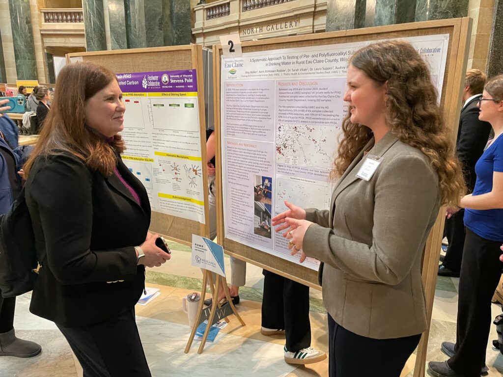 Photo: At the Research in the Rotunda event in Madison, Meg Walker, right, presents her PFAS research to Kathy Blumenfeld, secretary of the Wisconsin Department of Administration.