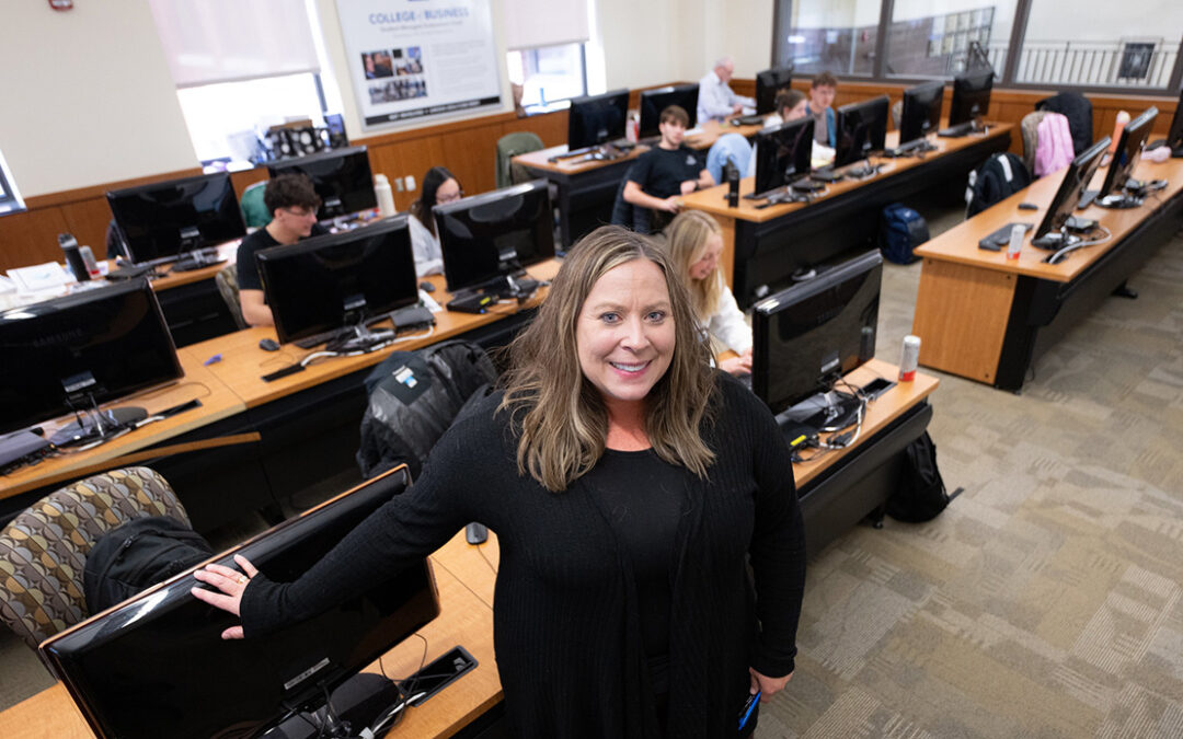 Photo: Cori Thomas ’96, ’04 MBA, an adjunct accounting instructor at UW-Oshkosh, supervises students preparing tax returns during a Volunteer Income Tax Assistance (VITA) session in Sage Hall’s Finance Trading Room. The program provides free tax preparation for qualifying community members while giving students hands-on experience working with real clients.