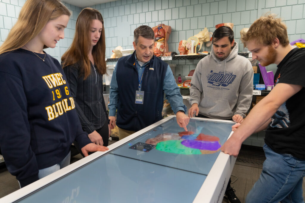 Photo: Mayo Health System medical professional, speech language therapist, Thomas Sather, discussed the human brain using anatomage technology with honors students during an honors class. Sather's is also an associate professor in the Communication and Sciences Disorders department.