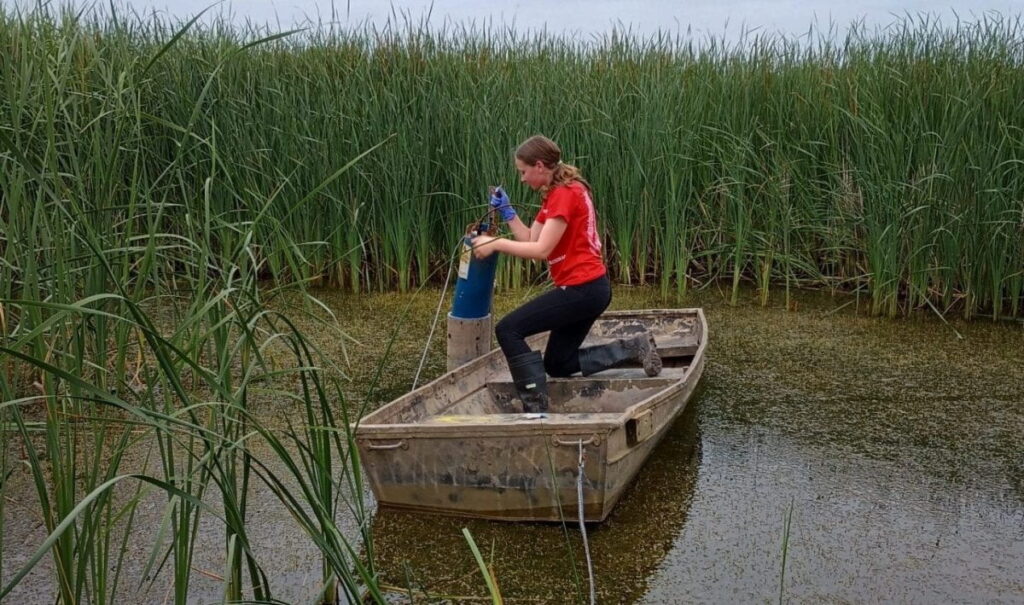 Photo of a high school Freshwater Scholar installing a dissolved phosphorus sensor.