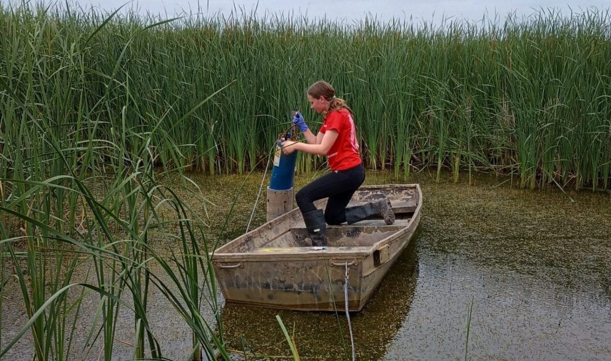 Photo of a high school Freshwater Scholar installing a dissolved phosphorus sensor.