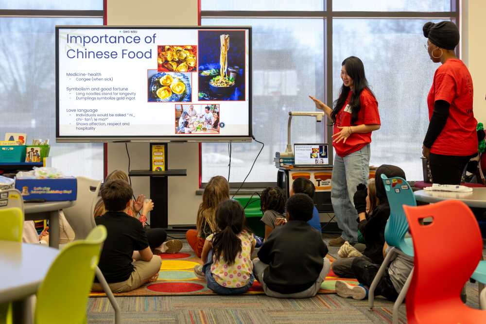 Photo: UWL students in the Chinese Studies program engage kids in an after-school Chinese Clubs at a local elementary school. Students learned about Chinese food, among other topics.