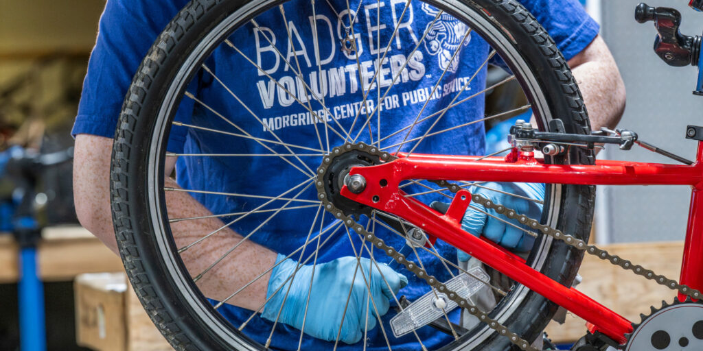 Photo of UW-Madison Badger Volunteers repairing a bicycle