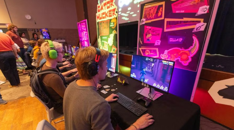 Photo: Stout Game Expo attendees play Gator Hucker, one of the student-designed games.