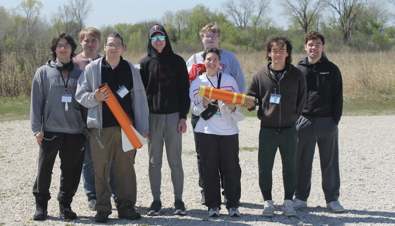 Photo: The UW-River Falls Falcon Rocketeers pose for a photo with their winning rocket at the 2026 NASA Wisconsin Space Grant Consortium Collegiate Rocket Launch Competition, held April 24-25 at Richard Bong State Recreational Area in Kansasville. Pictured L-R: Raidyn Bilotta, Sam Sackett, Jonathan Tabora, Peter Bendel, Evan Sander (back), Brook Mclaird (front), Mauricio Cuevas, Ian Vanveen. Contributed photo.