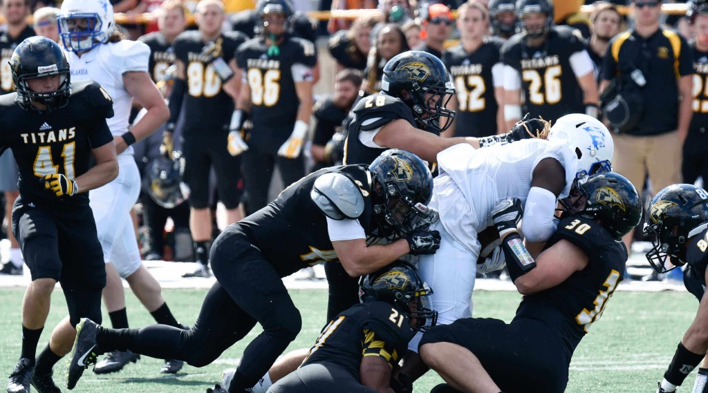 Members of the UW-Oshkosh Titans football team, shown in action against Finlandia University last September, will be testing WeightUp monitors to count reps and test for proper form in their weightlifting routines. PHOTO © UW-OSHKOSH INTEGRATED MARKETING COMMUNICATIONS - See more at: http://news.wisc.edu/uw-spinoff-tracks-weightlifter-safety-performance/#sthash.a443wLZO.dpuf