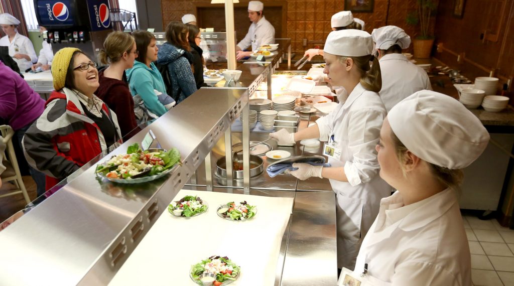 UW-Stout students serve food at a campus café as part of the Quantity Food Production class. The university’s School of Hospitality Leadership has been ranked No. 10 in the world by CEOWorld magazine.