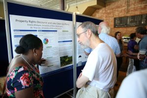 Eniola Afolayan, a UW-Stout LAKES researcher from University of Mary Washington in Virginia, talks about her project during a 2015 community presentation at the Raw Deal in Menomonie. 
