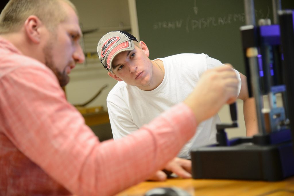 A UW-Oshkosh student works with a faculty member.