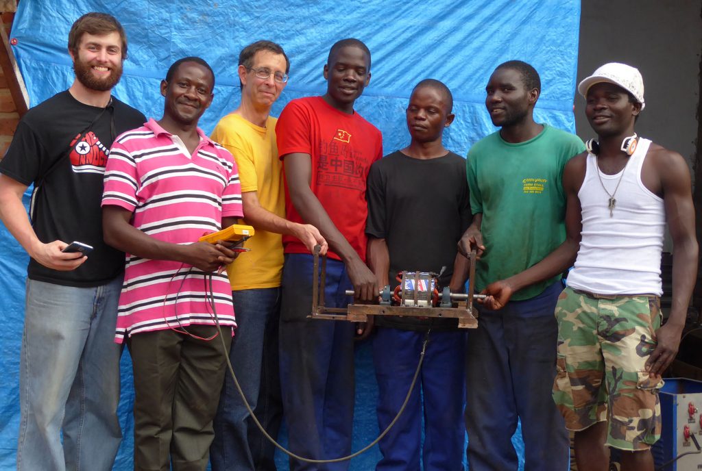 Hastings Mkwandwire and other village residents experimented with ways to build generators. UW-Stout student Josh Miller, left, later built a new prototype. Miller and Professor Tom Lacksonen, third from left, visited Malawi in January.