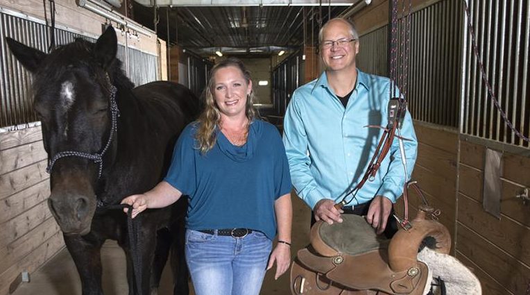 UW-River Falls student innovator Shanna Burris helps paraplegic horseback riders