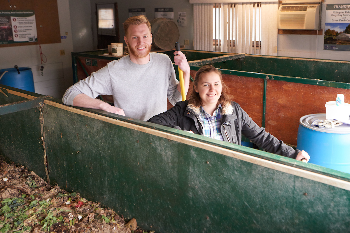 UW-La Crosse student Jeremy Shimetz and Andrea Schaefer, ’16, stand by the vermicomposter, a 5 x 4 x 32-foot box that is home to tens of thousands of worms. Only pre-consumer food waste is added to the pile.