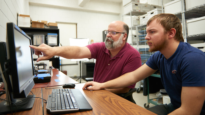 From left, David Anderson, UWL associate professor of archaeology, and UWL senior William Feltz are using cutting edge technology to make ancient artifacts easier to see — and feel. 