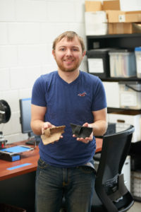 UWL senior William Feltz holds a pottery fragment and a 3D printed model of one. After graduating, Feltz will begin work as a field technician for a Colorado State University archaeology excavation project at Ft. McCoy to analyze archaeological remains from the site prior to building.