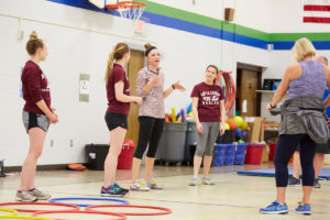 UWL Physical Therapy graduate student Elizabeth Skaer shares educational information during a break time in the circuit training at Summit Elementary School in La Crosse. The fitness program the UWL Physical Therapy students created has a unique blend of aerobic activity and education. It is one of many PT program health and wellness initiatives UWL students are creating throughout the community. 