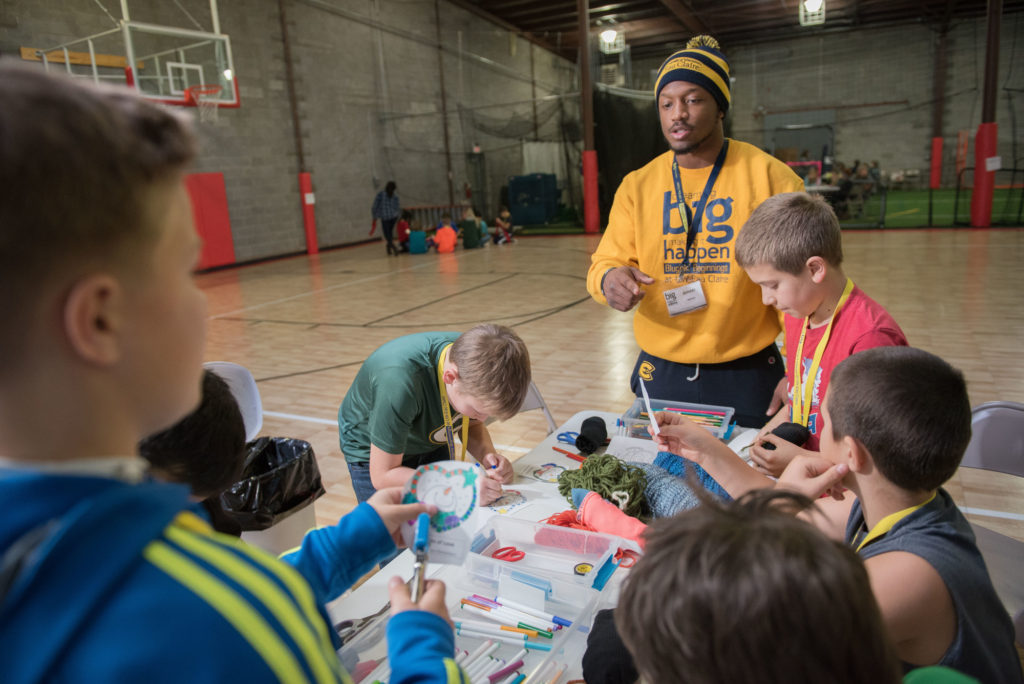 UW-Eau Claire student Ameer Collins, a participant in the Blugold Beginnings Learning Community, works with fifth-grade students from Manz Elementary School in Eau Claire during a citizenship and service event organized by the learning community members.