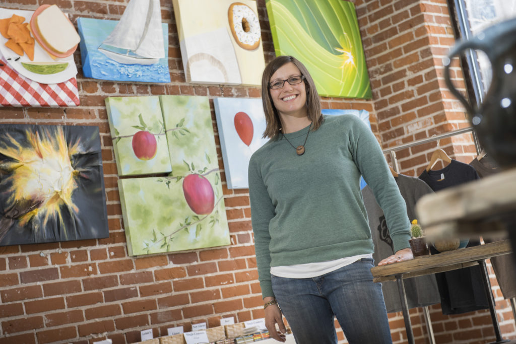 UW-Eau Claire alumnus Erin Klaus stands in the new location of Tangled Up In Hue, the art collective she and her business partner have operated in downtown Eau Claire since 2009. Klaus says her undergraduate experience at UW-Eau Claire was a big factor in the decision to start a business downtown, and the business has grown amid an overall revitalization of the area. 