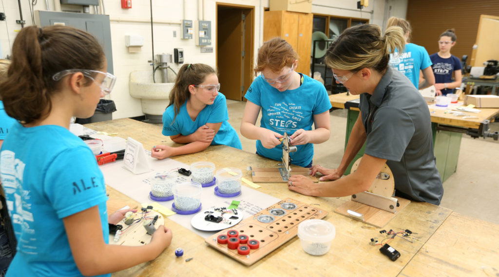 Kari Berthiaume helps STEPS for Girls participants with their robot projects in an engineering lab at UW-Stout.