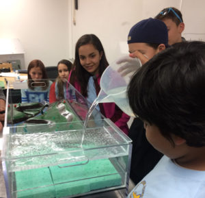 Students from the LCO Ojibwe school try an environmental science experiment in May while visiting UW-Stout.