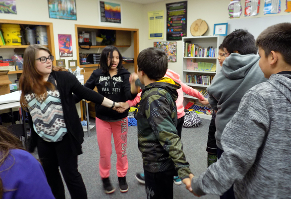 UW-Stout student Skylar Kitchner leads a career and education development activity with LCO sixth-graders.
