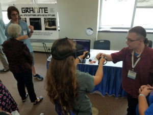 Photo of UW-Stout students Austin Lewer, left, and Daniel Johnson, explaining the Granite virtual reality project at the WiSys innovation symposium held in July at UW-Platteville.