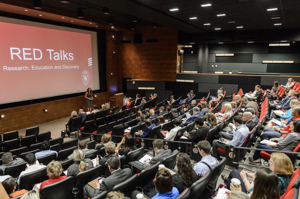 Photo: A series of talks, titled RED Talks, are presented by UW faculty and staff during the Office of Corporate Relations (OCR) Day On Campus event held in Varsity Hall in Union South at the University of Wisconsin-Madison on Aug. 23, 2017. (Photo by Bryce Richter / UW-Madison)