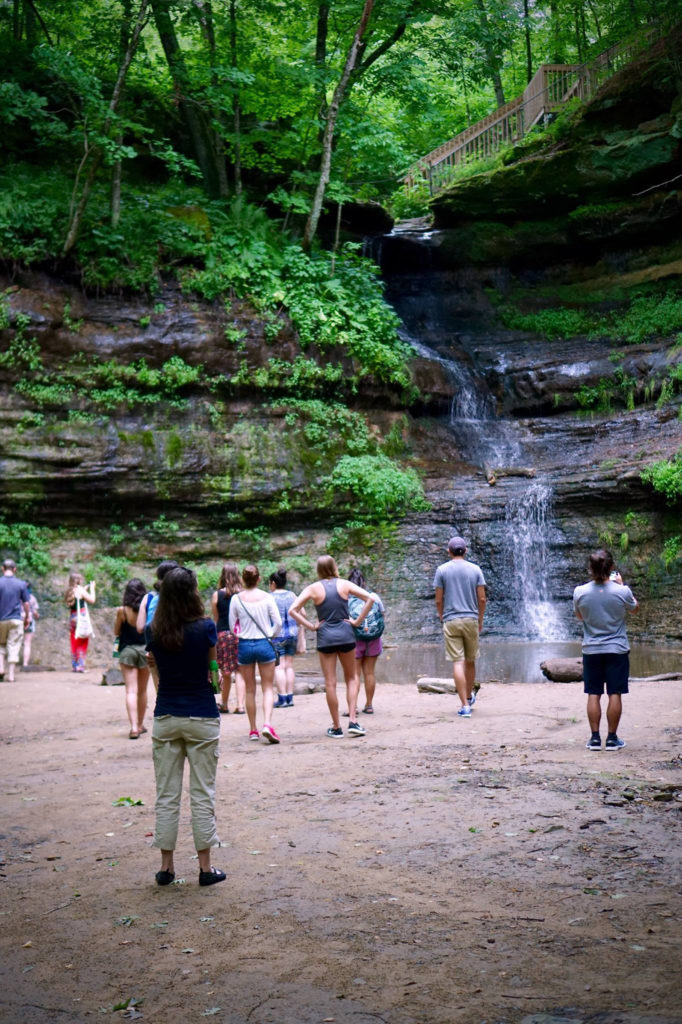 Photo of LAKES REU students at UW-Stout visiting Devil’s Punch Bowl rock formation along the Red Cedar River near Menomonie.